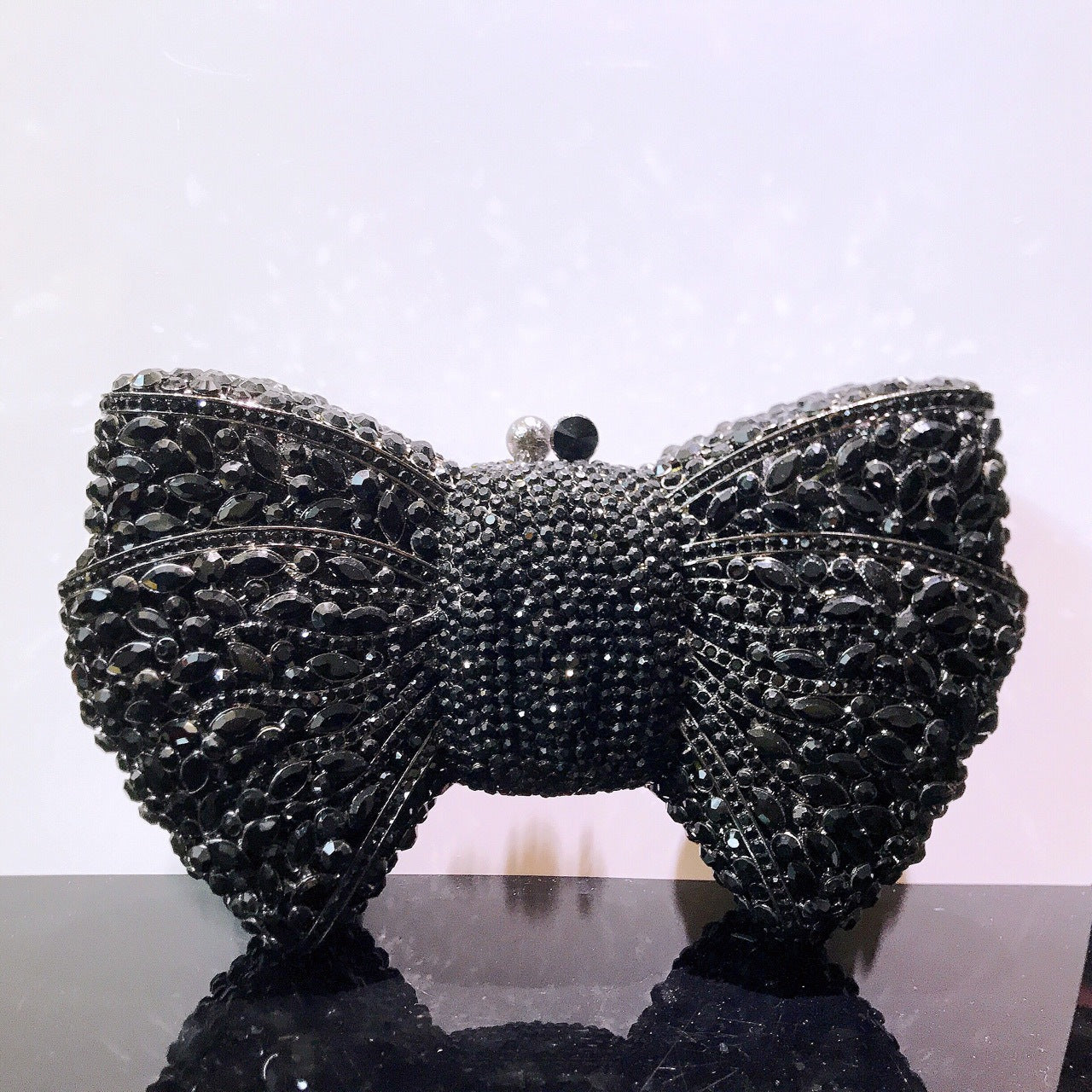 MRY · Diamond-encrusted bow dinner bag