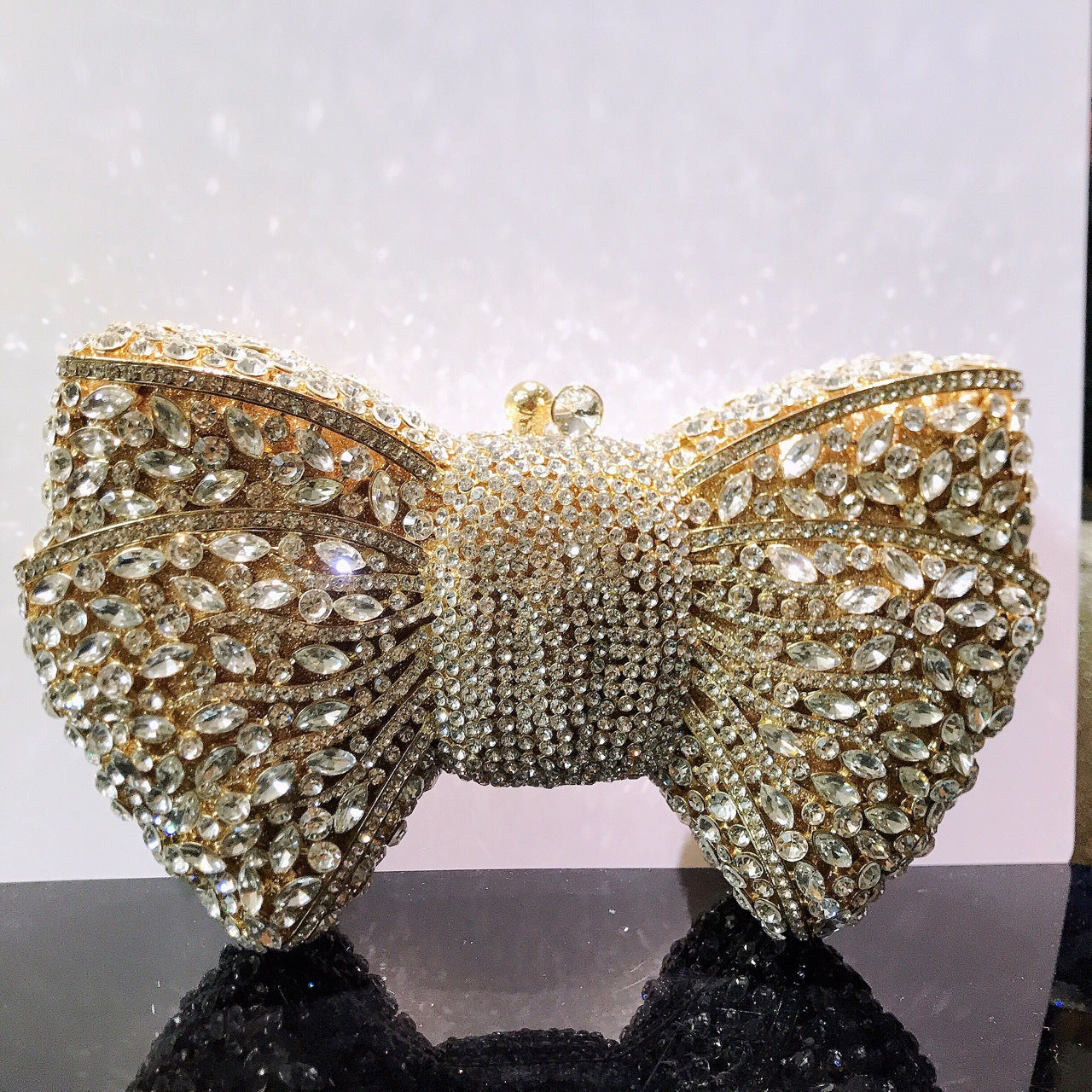 MRY · Diamond-encrusted bow dinner bag